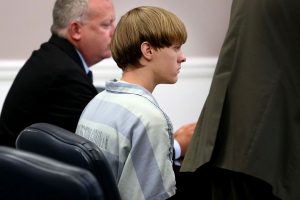 Dylan Roof (C), the suspect in the mass shooting that left nine dead in a Charleston church last month, appears in court July 18, 2015 in Charleston, South Carolina. The Associated Press, WCIV-TV and The Post and Courier of Charleston are challenging a judge's order issued last week that prohibits the release of public records in the June 17 shooting at Emanuel African Methodist Episcopal church. (Photo by Grace Beahm-Pool/Getty Images)