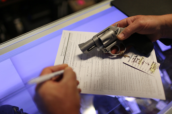 Mark O'Connor fills out his Federal background check paperwork as he purchases a handgun at the K&W Gunworks store on the day that U.S. President Barack Obama in Washington, DC announced his executive action on guns on January 5, 2016 in Delray Beach, Florida.  (Photo by Joe Raedle/Getty Images) 