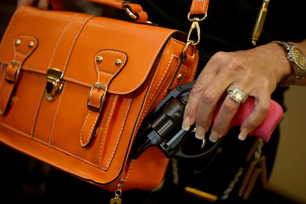 BOCA RATON, FL - OCTOBER 21:  Susan Kushlin poses with a concealed-carry handbag that her company, Gun Girls, Inc., created for women that enjoy guns. (Photo by Joe Raedle/Getty Images)
